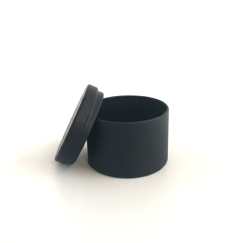 Black Travel tin container with lid on a white background